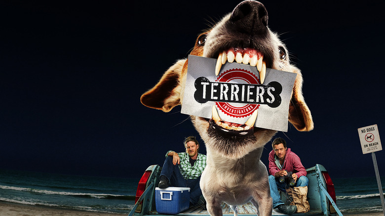 Angry dog holding Terriers logo