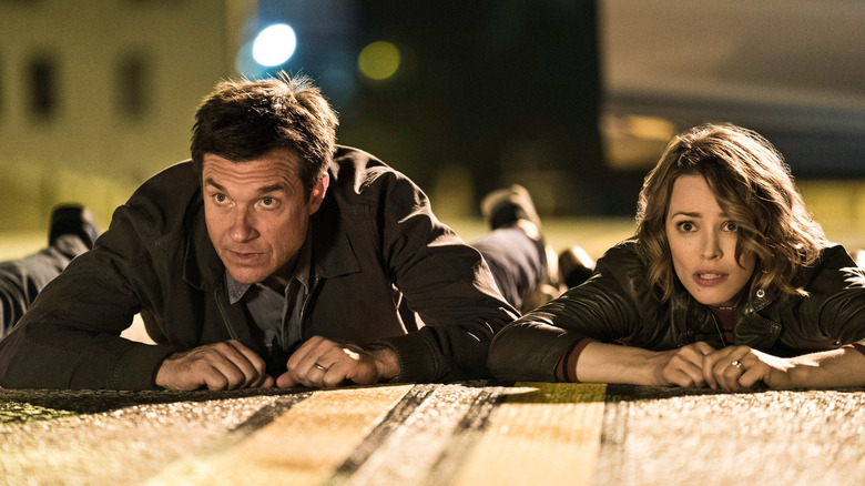 Jason Bateman and Rachel McAdams lay on the ground