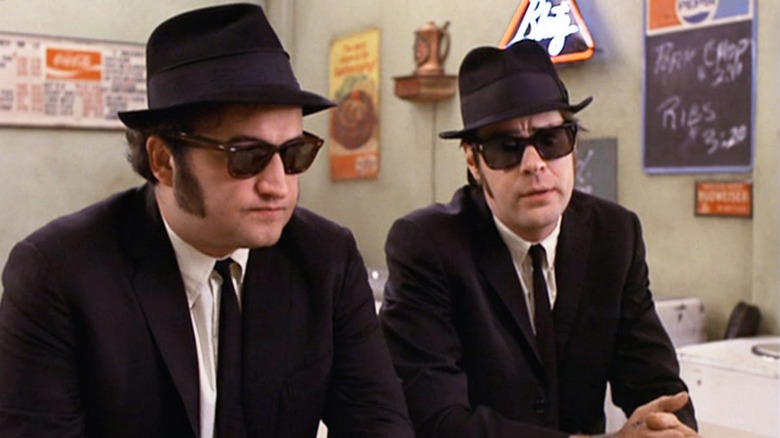 The Blues brothers sit at a table