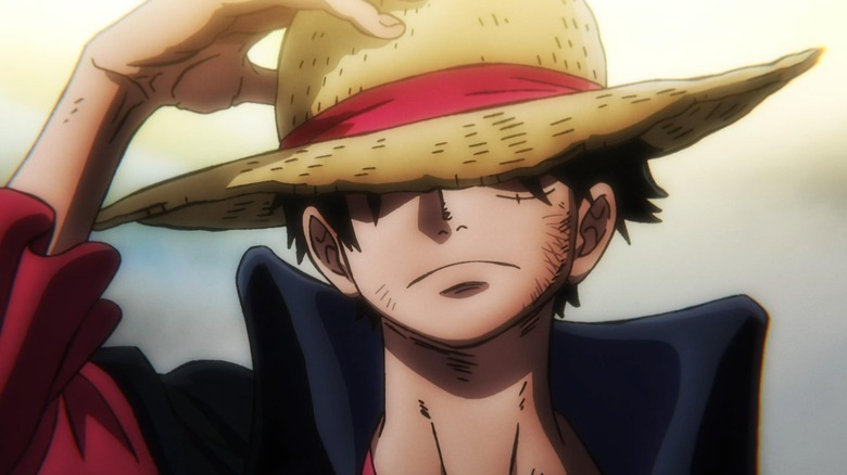 Luffy holds hat over eyes