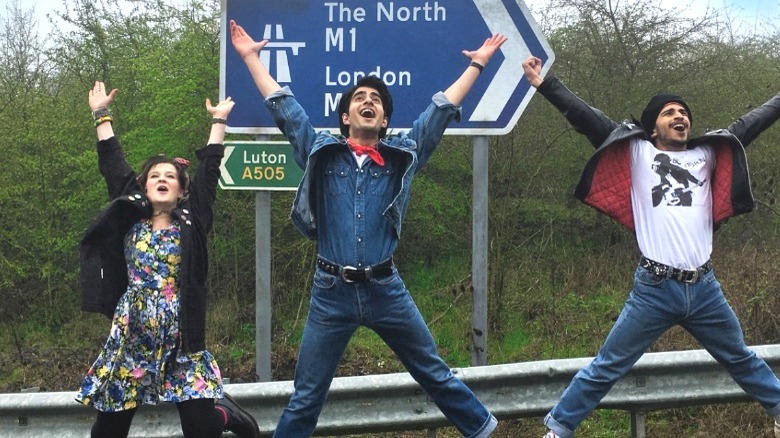 Javed smiling and jumping with arms up