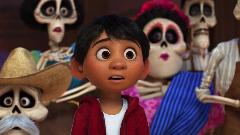 Miguel wearing a red jacket, surrounding by skeletal spirits