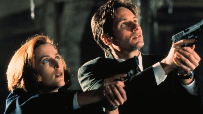 Scully and Mulder holding guns