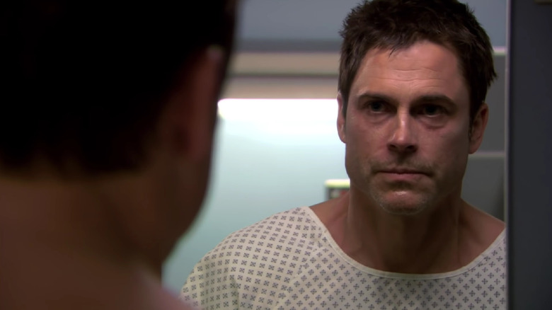 A sick Rob Lowe looks at himself in the mirror