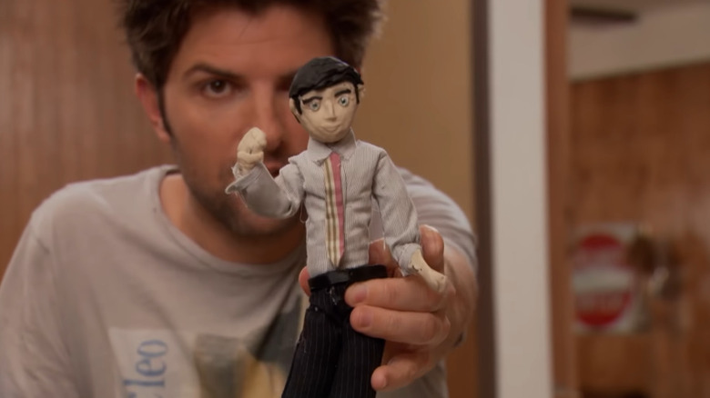 Ben Wyatt holds a clay model of himself