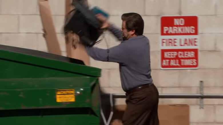 Ron Swanson throws a computer in a dumpster