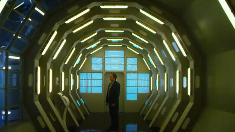 Man standing in futuristic corridor