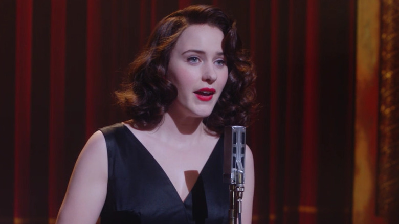 Mrs. Maisel speaking into microphone