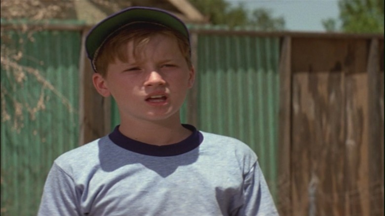 Kid in a baseball hat, talking