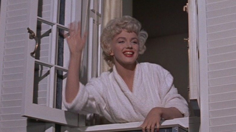 Marilyn Monroe waving through window