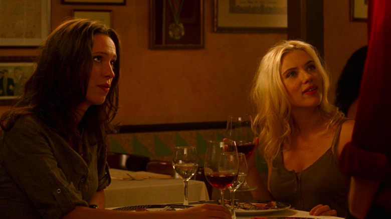 Rebecca Hall and Scarlett Johansson seated at dinner table