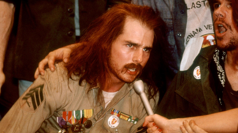 Ron Kovic shouting into reporters' microphone during protest