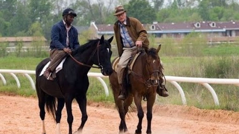 Two men ride horses