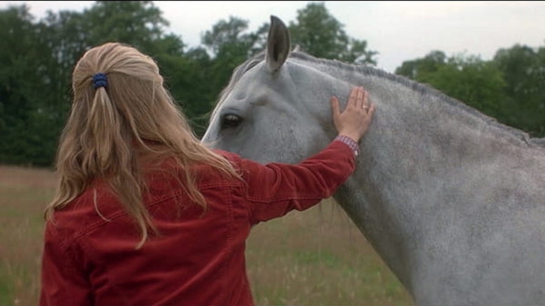  Ariana Richards pets a horse