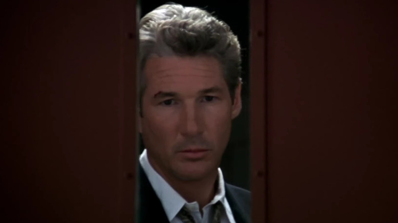 Richard Gere looks through a door