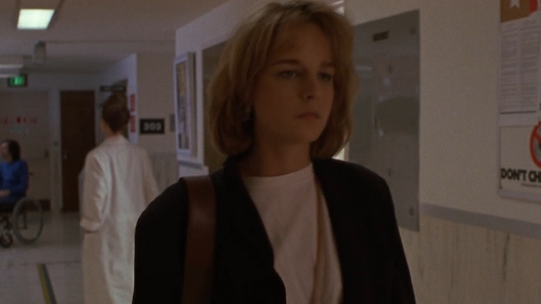 Helen Hunt walks down a hospital hallway