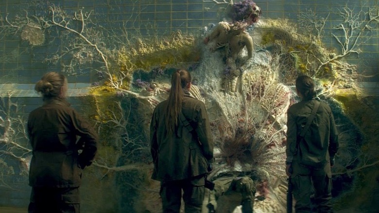 Lena and the others investigate a corpse in "Annihilation" (2018)