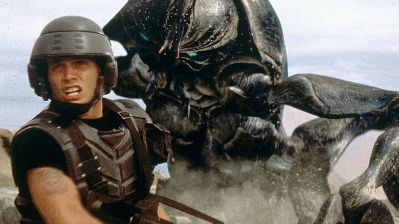 Rico fleeing bugs in "Starship Troopers" (1997)