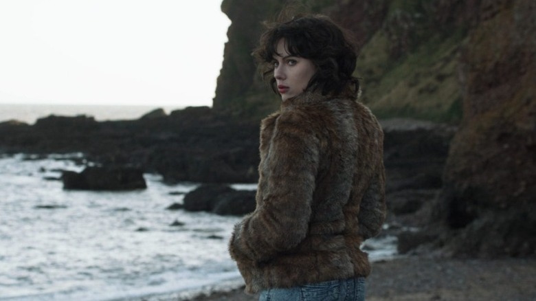 The woman stands at the shoreline in "Under the Skin" (2013)