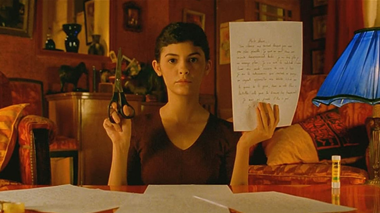 Amelie holding scissors and paper