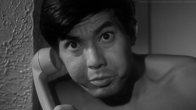 Joe Shishido holding a phone