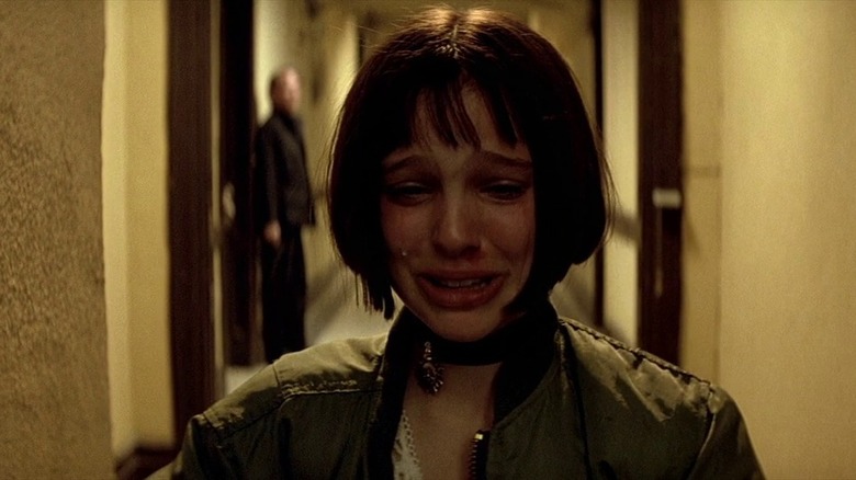 Mathilda crying as she walks down a corridor