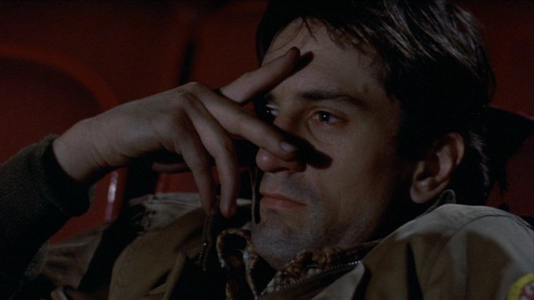 Travis Bickle watching movie through his fingers