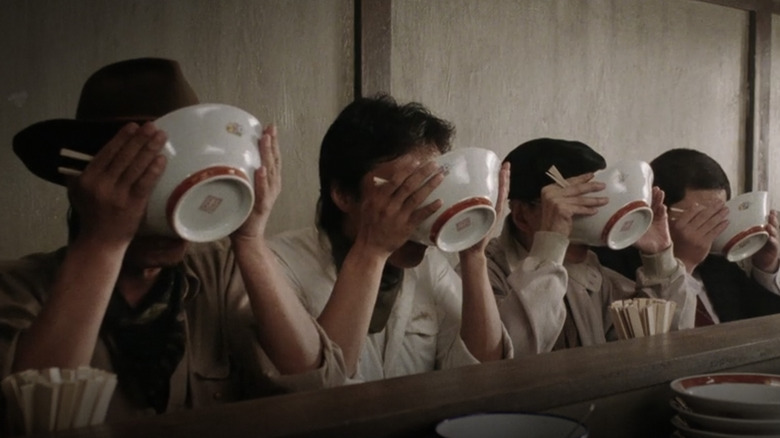 People slurping from ramen bowls