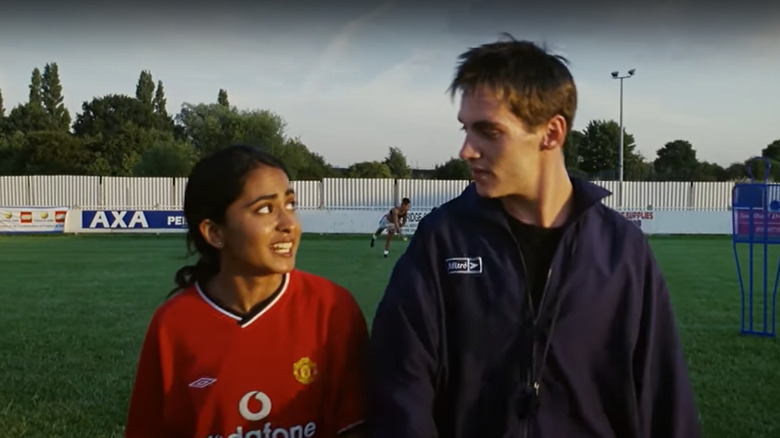 Jess and Joe talk on soccer field