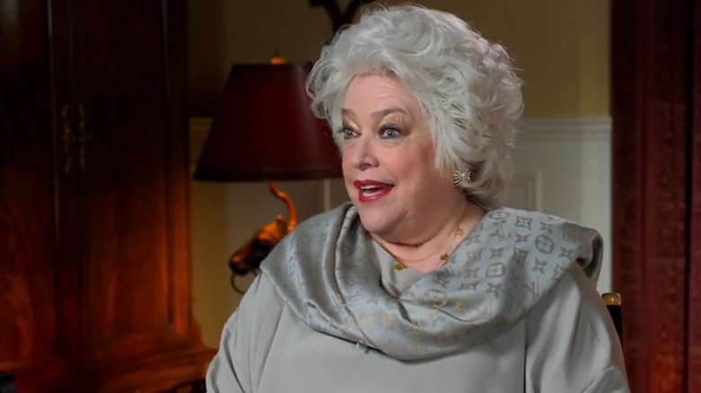 Kathy Bates dressed as Ida Marquette for behind-the-scenes interview