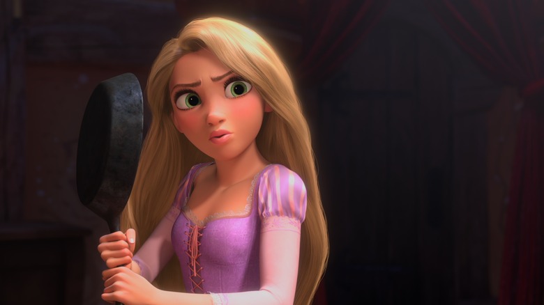 Rapunzel holds frying pan