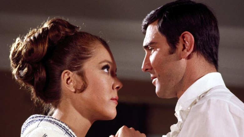 George Lazenby and Diana Rigg staring at each other