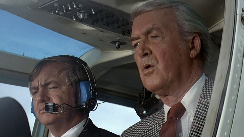 Phillip Stevens sitting by pilot in helicopter