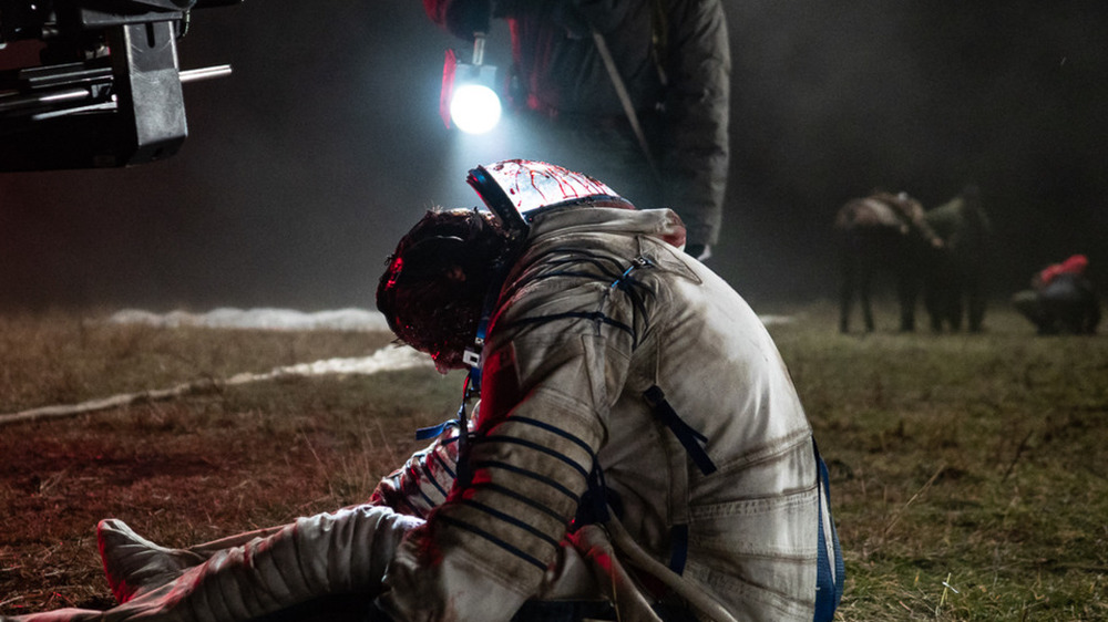 Man shines light bleeding cosmonaut