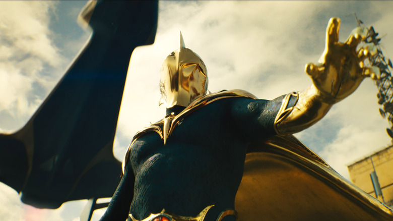 Doctor Fate waves a hand as a jet flies overhead