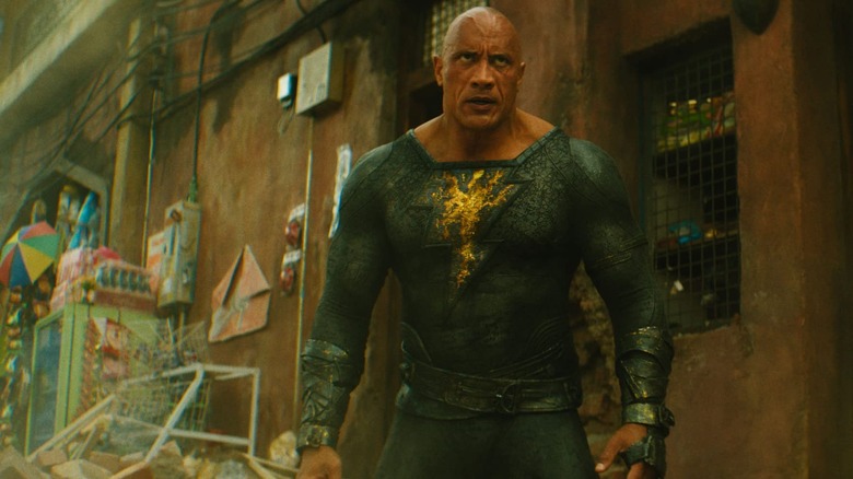 Black Adam stands on a city street, glaring