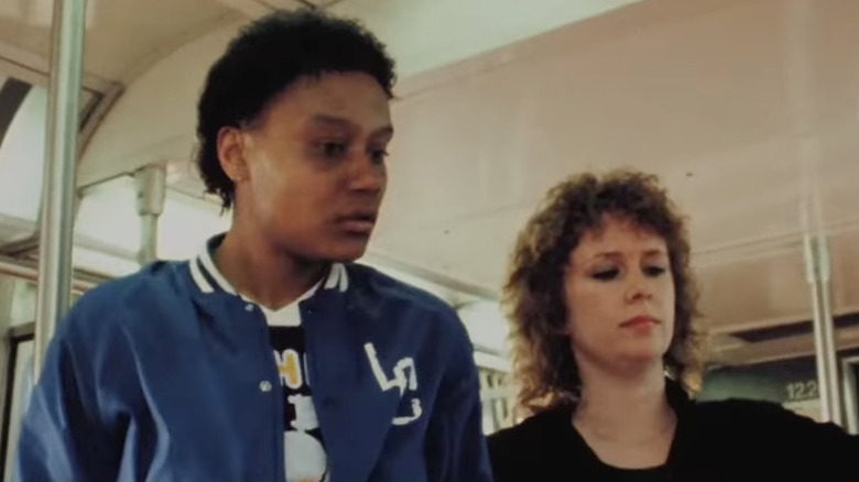 Two women look down on subway