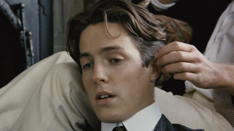 Hugh Grant gets face caressed