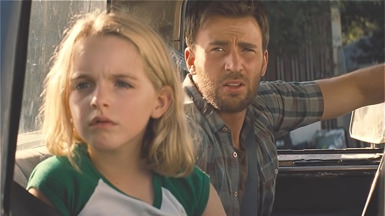 Chris Evans and girl sit in pickup truck