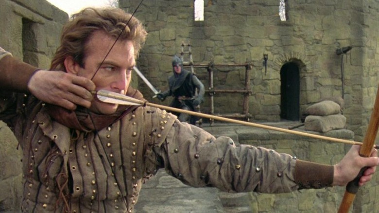 Kevin Costner shooting an arrow