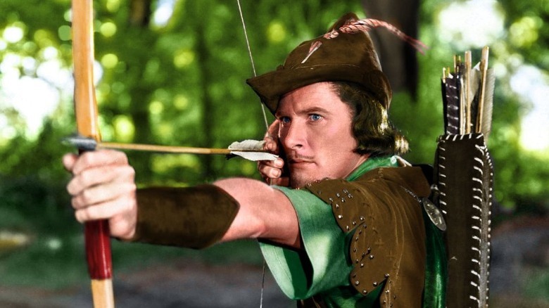 Errol Flynn as Robin Hood shooting an arrow