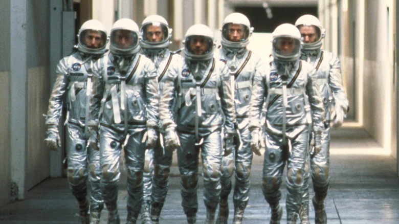 The Mercury astronauts walking in spacesuits