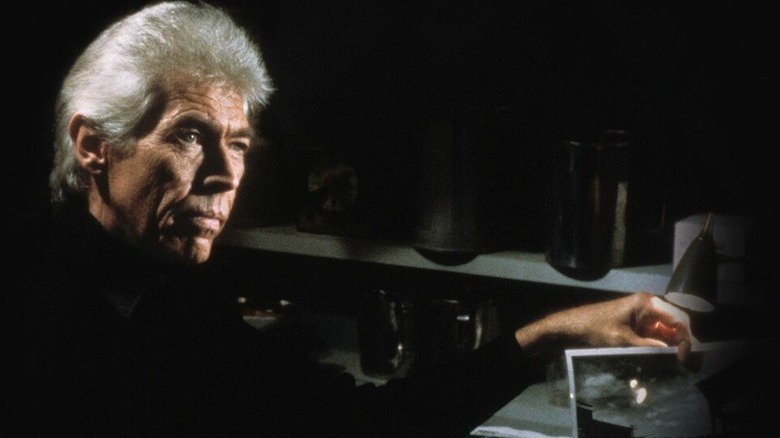 James Coburn holding picture