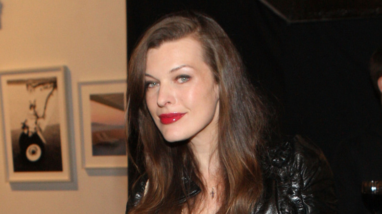 Milla Jovovich leans forward