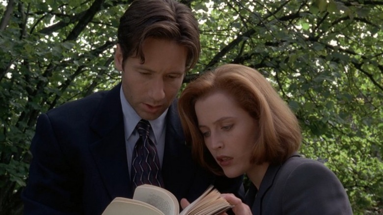 Mulder and Scully examine a book