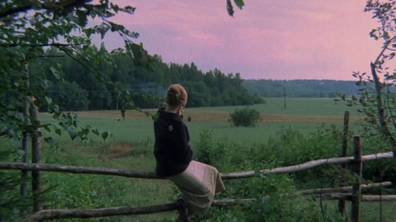 Girl looking at fields in The Mirror