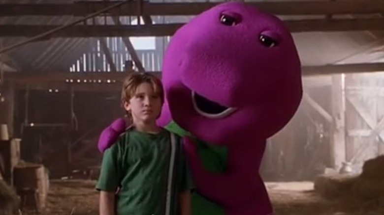 Barney the dinosaur helps child