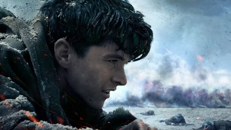 Tommy falls to the ground during a battle in "Dunkirk"