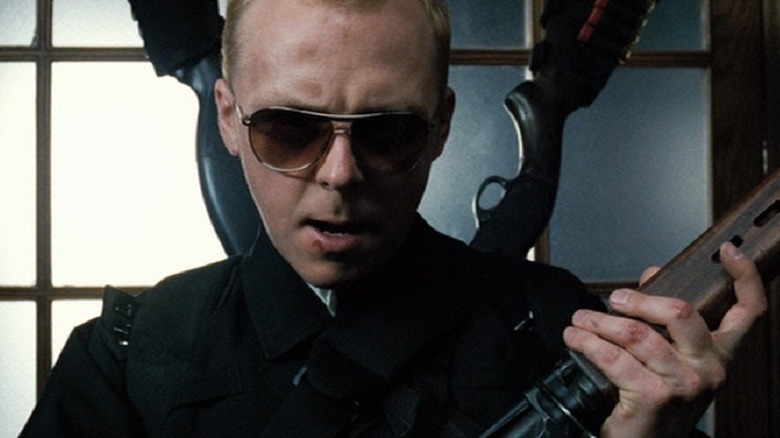 Simon Pegg holding guns