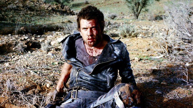 Mad Max sits bleeding in the desert in "The Road Warrior"